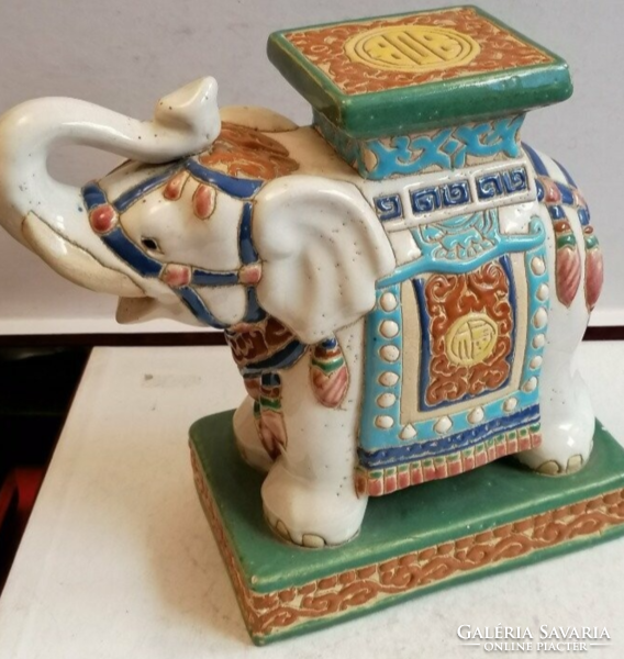 Ceramic elephant holding a flower