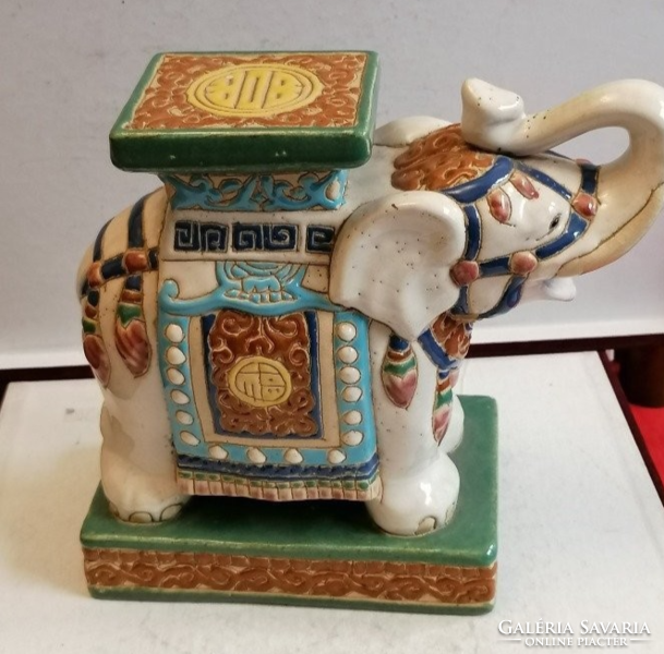 Ceramic elephant holding a flower