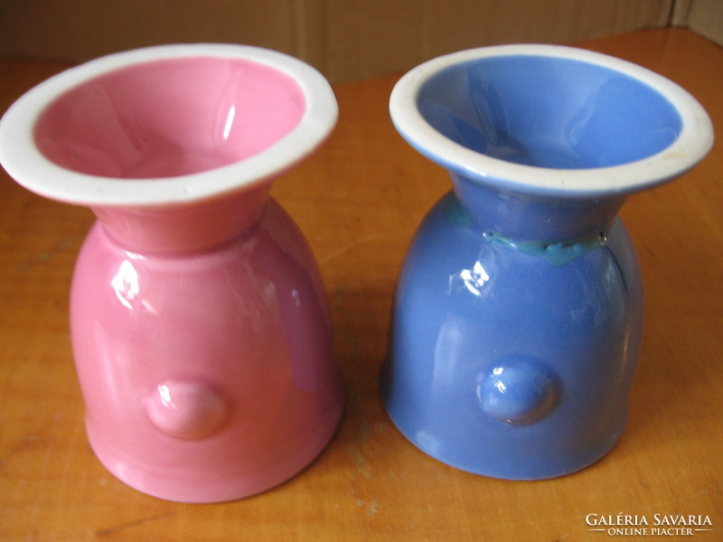 A pair of egg holders with funny face noses