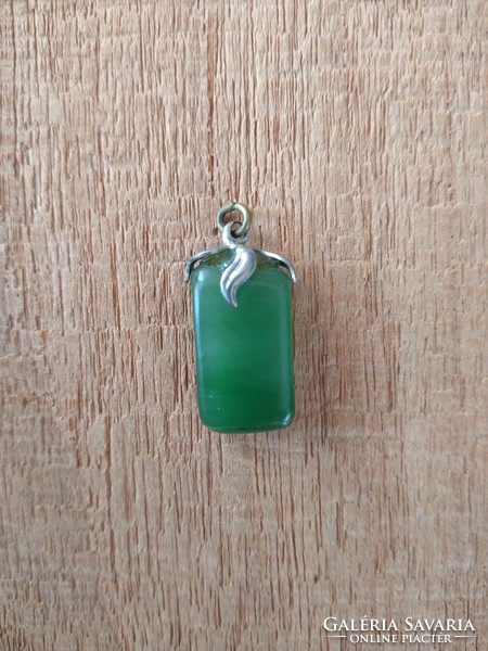 Jade pendant in a metal socket