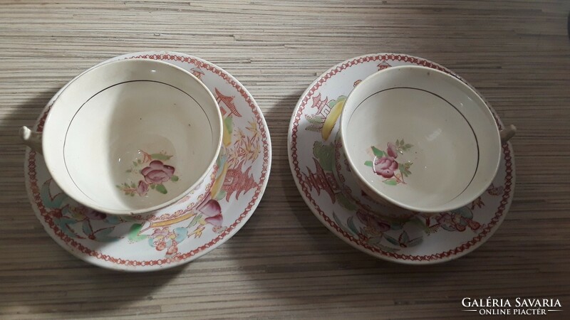 2 antique oriental-patterned faience tea cups with a small plate.