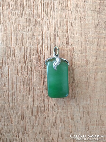 Jade pendant in a metal socket