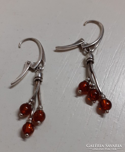 In good condition marked sterling silver hook earrings studded with real amber stones