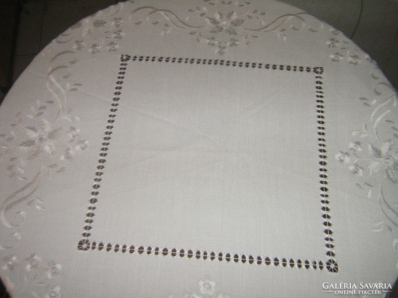 Beautiful white vintage floral machine-embroidered round tablecloth with a slinged edge