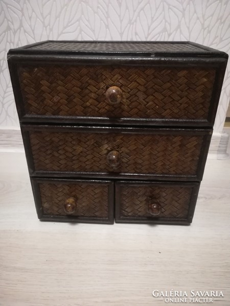 Small storage cabinet made of wood with 4 rattan drawers