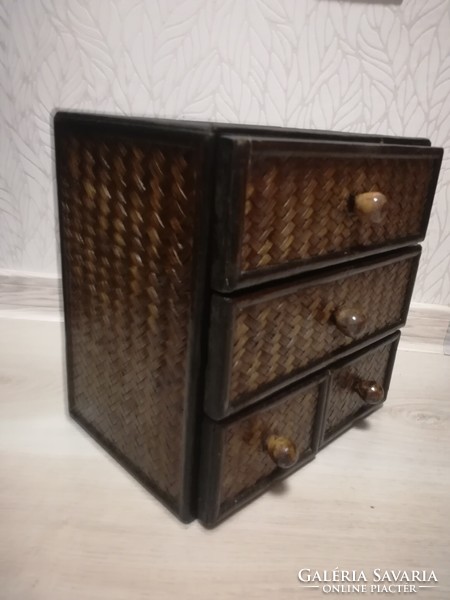 Small storage cabinet made of wood with 4 rattan drawers