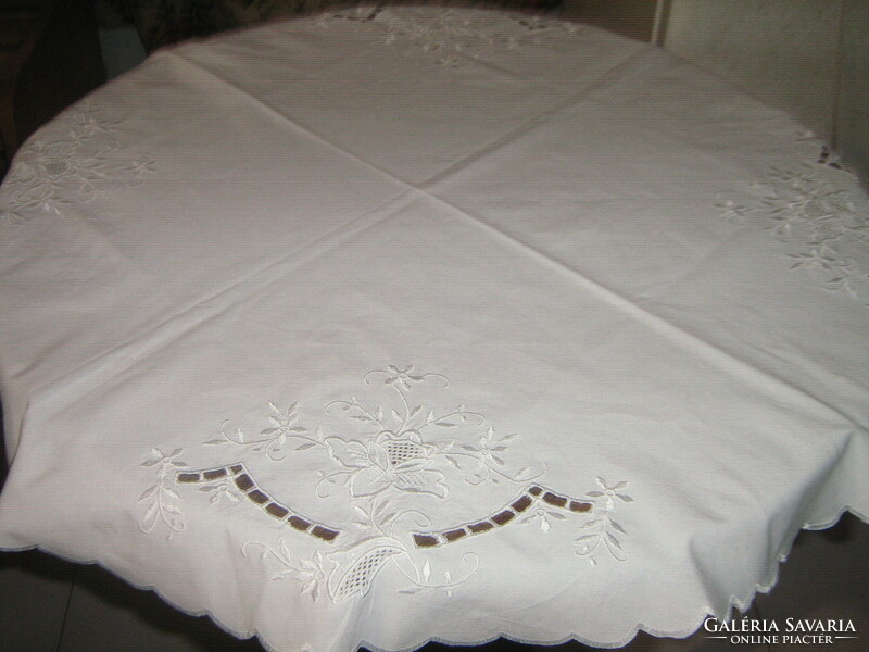 Beautiful white vintage floral machine-embroidered round tablecloth with a slinged edge
