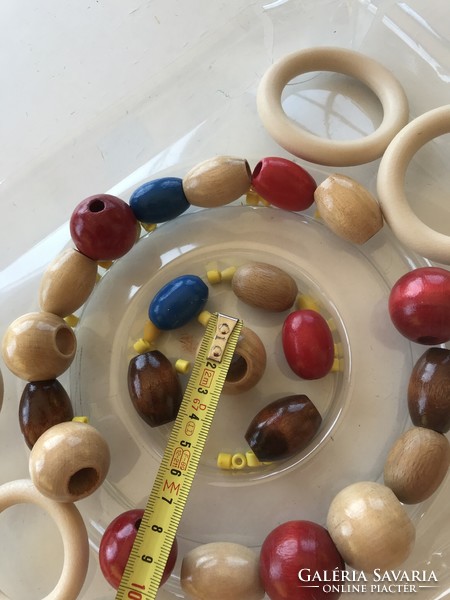 Colorful wooden balls and plastic hoops for creativity.