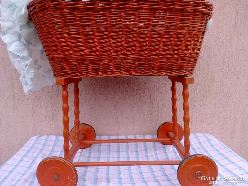 Retro rocking stroller with wooden frame, wicker basket with bedding, sunshade