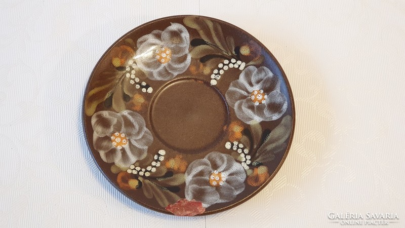 16 cm diameter, damaged, painted ceramic plate with flowers. Under the tile.