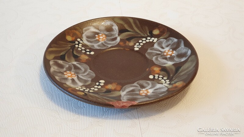 16 cm diameter, damaged, painted ceramic plate with flowers. Under the tile.