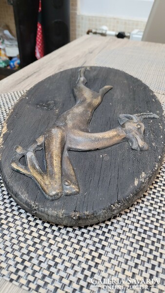 Vintage jumping chamois made of copper on a wooden base. Wall decoration.
