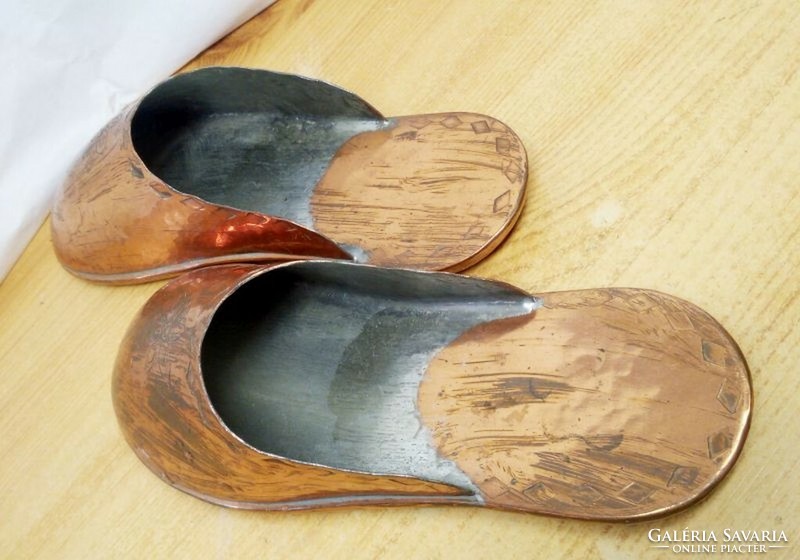 A pair of handmade red copper slippers, a rarity that can be placed on the wall or on a shelf