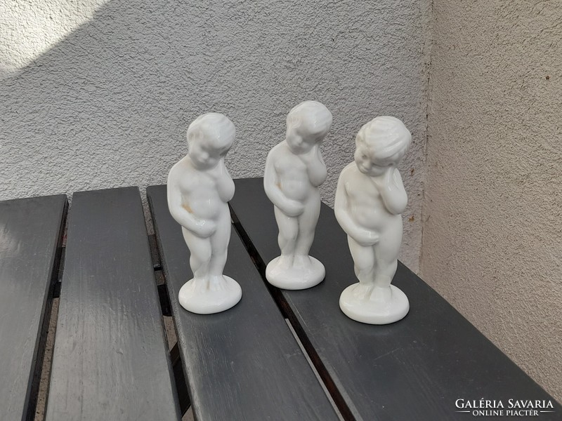 3 peeing porcelain boys in one