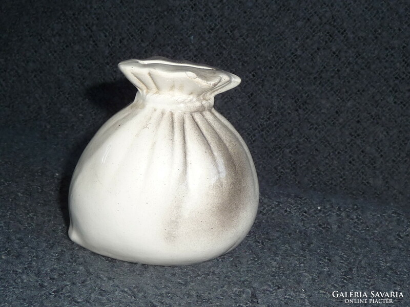 Old porcelain socket in the shape of a money bag. Earthenware socket in the shape of a money bag. 100-year-old socket figure