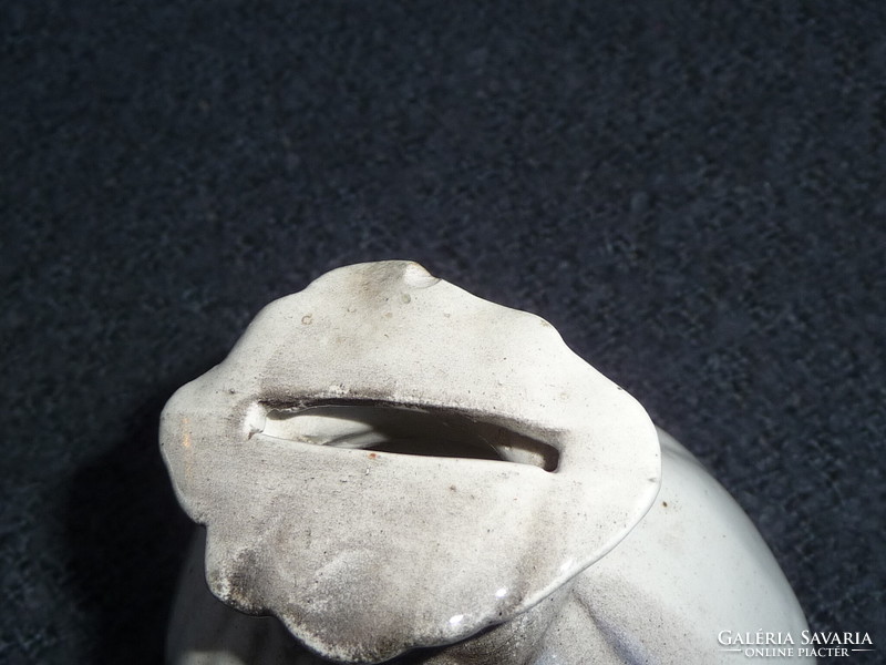 Old porcelain socket in the shape of a money bag. Earthenware socket in the shape of a money bag. 100-year-old socket figure