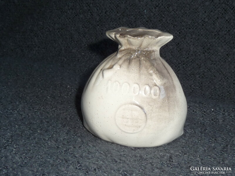 Old porcelain socket in the shape of a money bag. Earthenware socket in the shape of a money bag. 100-year-old socket figure