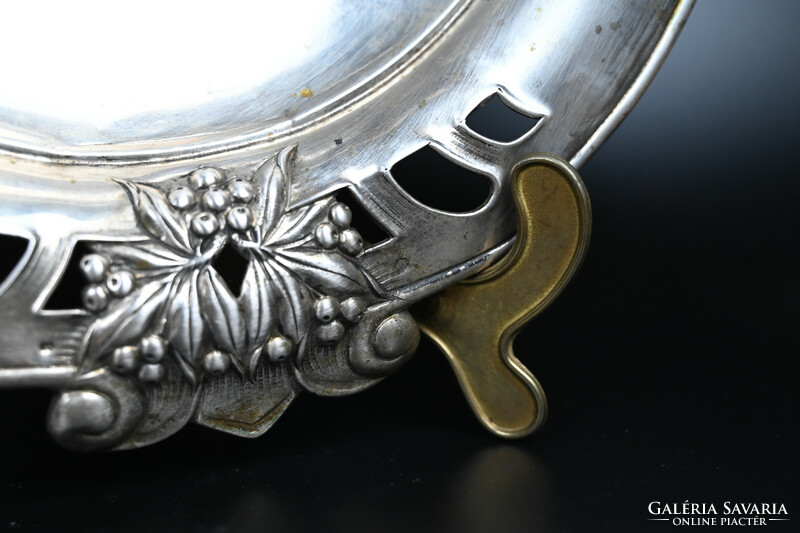 A beautiful, silver centerpiece, decorated with offering flowers and leaves