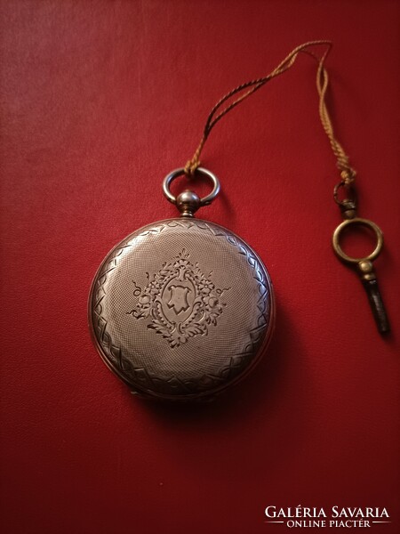 Flawless silver pocket watch with key