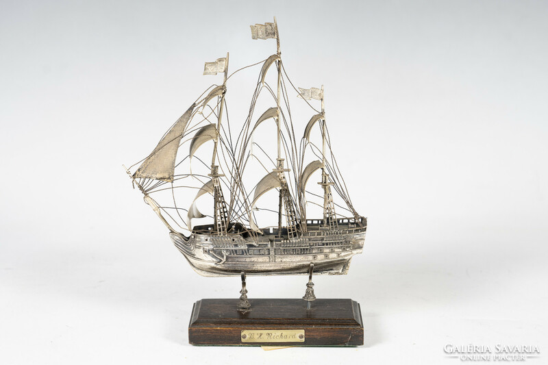 Silver ship on a wooden plinth