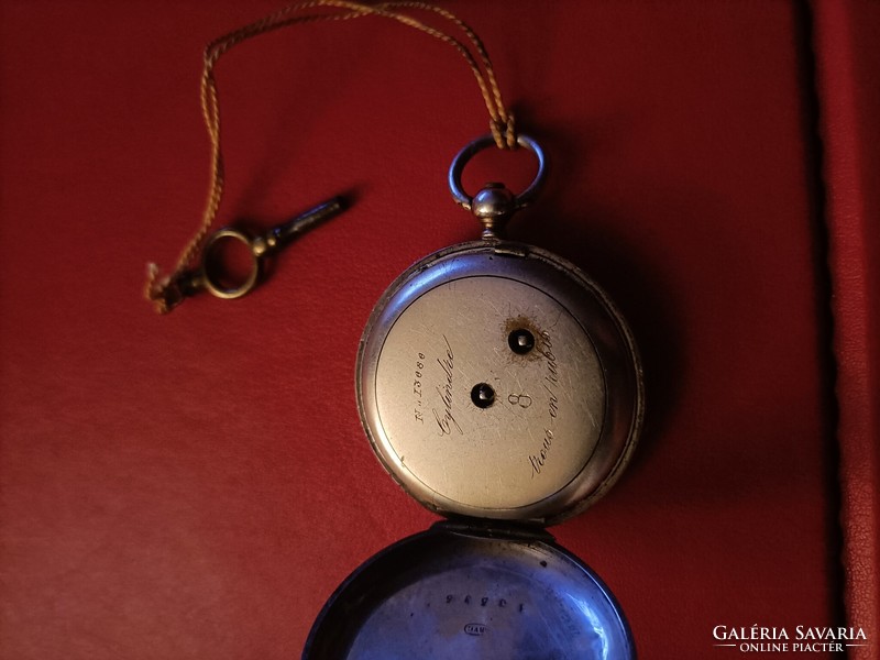 Flawless silver pocket watch with key