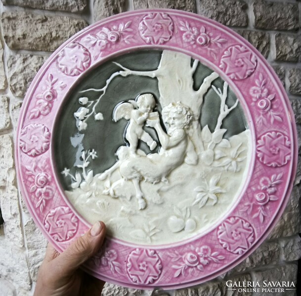 Antique wall plate schütz cilli majolica figural angel and faun .2. A pair is also for sale!
