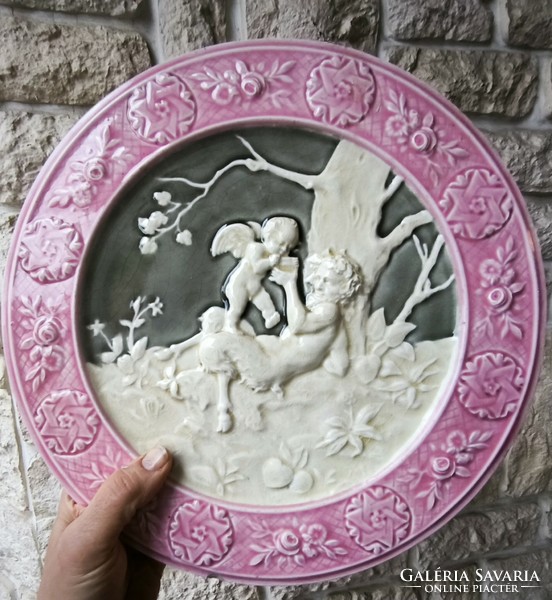 Antique wall plate schütz cilli majolica figural angel and faun .2. A pair is also for sale!