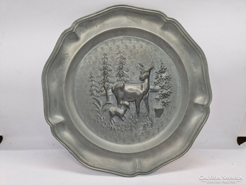 A pair of pewter wall decorations with a hunting scene