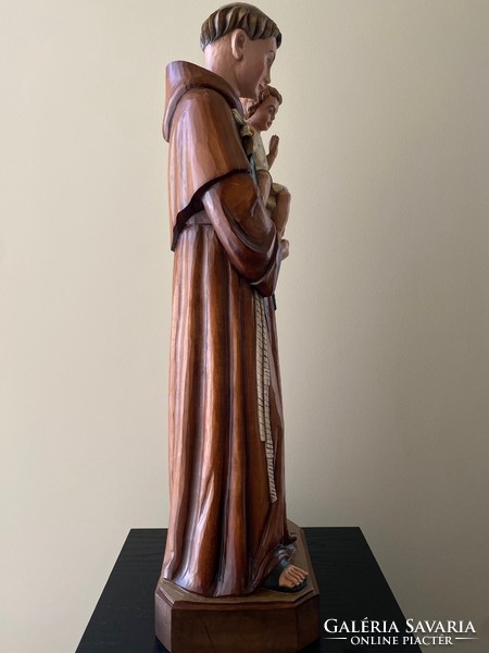 Saint Antal with the baby Jesus is a beautiful wooden carved statue