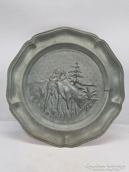 A pair of pewter wall decorations with a hunting scene