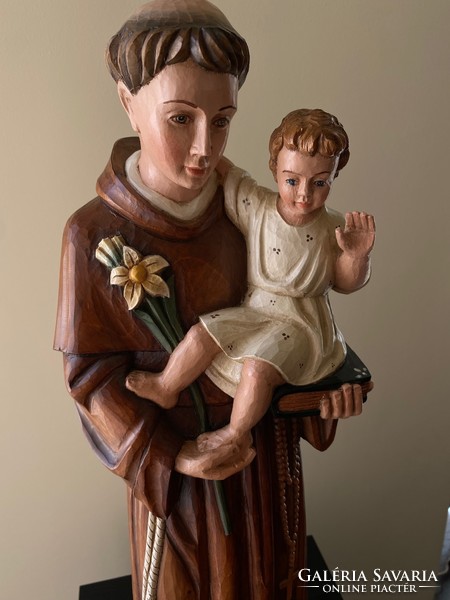 Saint Antal with the baby Jesus is a beautiful wooden carved statue