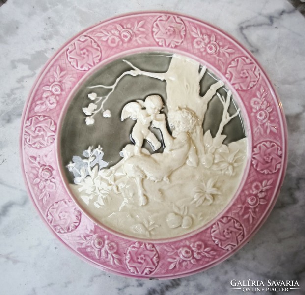 Antique wall plate schütz cilli majolica figural angel and faun .2. A pair is also for sale!