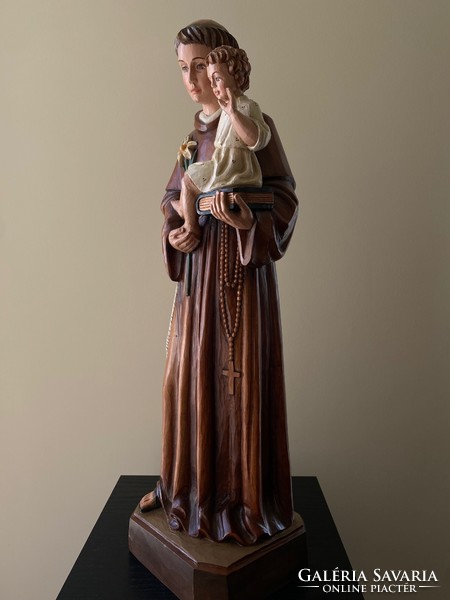 Saint Antal with the baby Jesus is a beautiful wooden carved statue