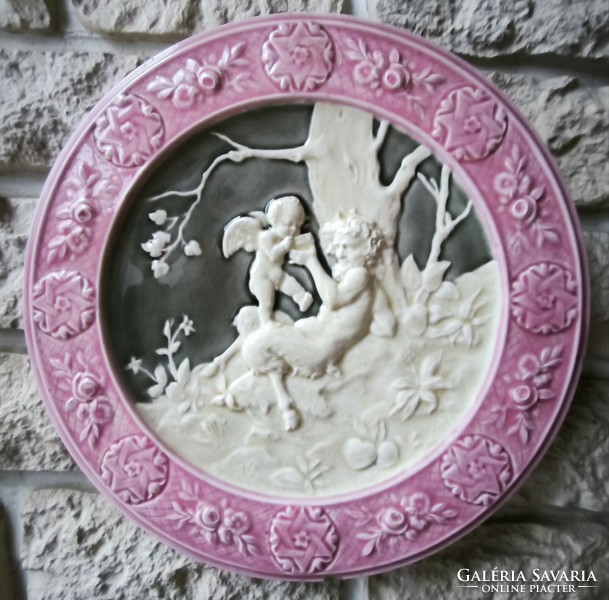 Antique wall plate schütz cilli majolica figural angel and faun .2. A pair is also for sale!