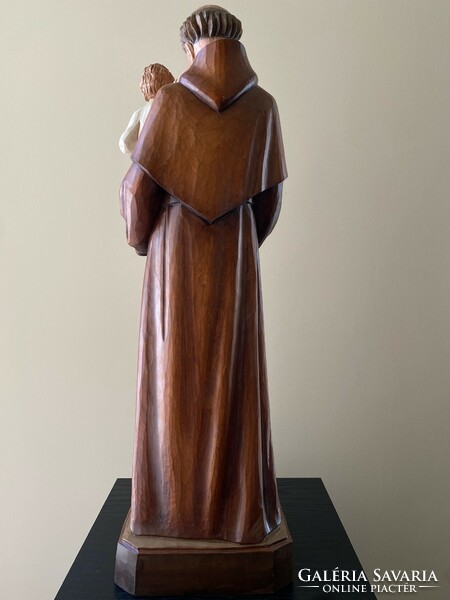 Saint Antal with the baby Jesus is a beautiful wooden carved statue