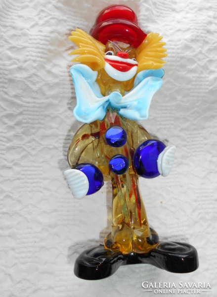 Handcrafted glass from Murano kept in a display case with a clown image,