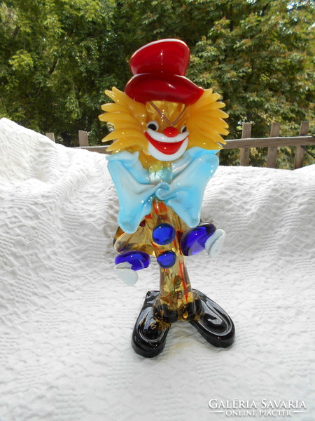 Handcrafted glass from Murano kept in a display case with a clown image,