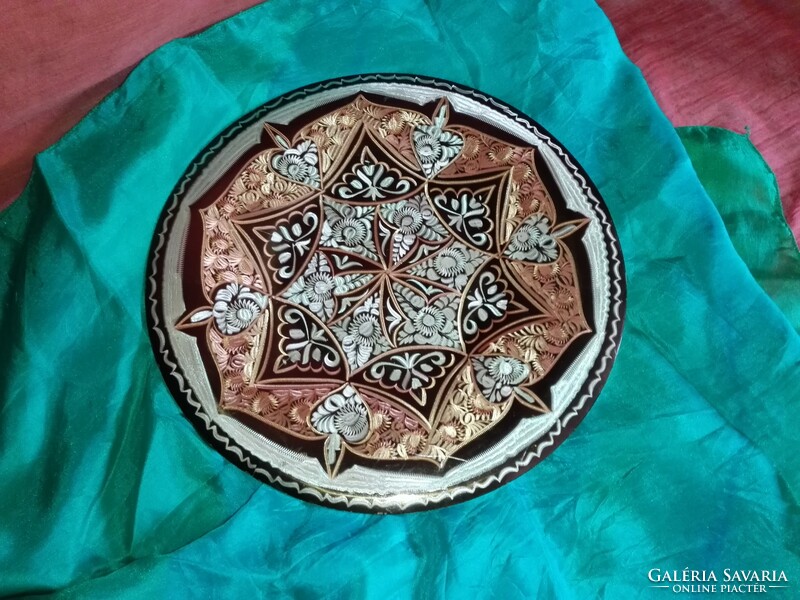 Red copper mandala plate.