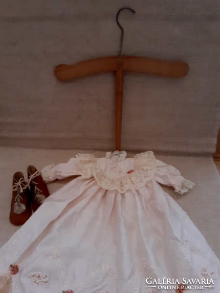 Old spared beautiful silk and chubby baby clothes with small leather shoes for it