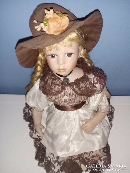 Porcelain doll with blonde pigtails