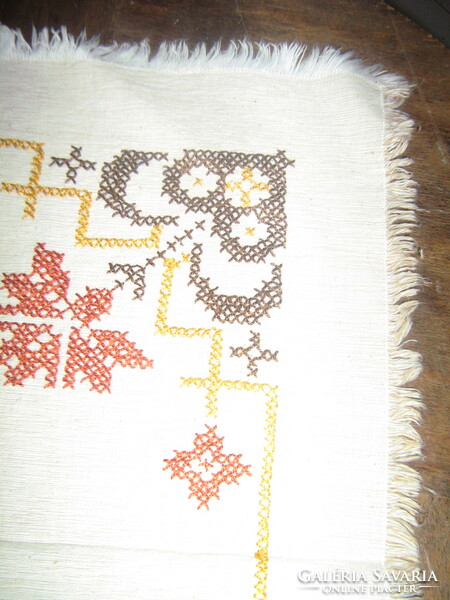 Beautiful antique hand-embroidered woven tablecloth with cross-stitch fringe