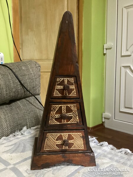 A small cabinet in the shape of a pyramid