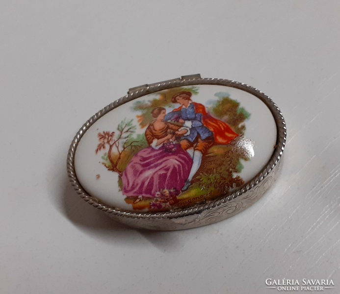 Old silver-colored chiseled small tin box with a porcelain scene insert on the top