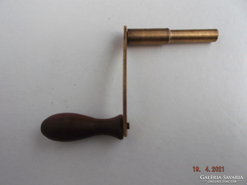 Winding key for weighted wall clock. Made of copper with a wooden coil.---1---
