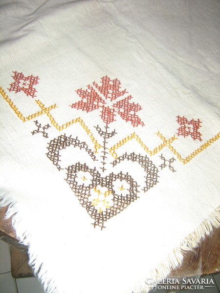 Beautiful antique hand-embroidered woven tablecloth with cross-stitch fringe
