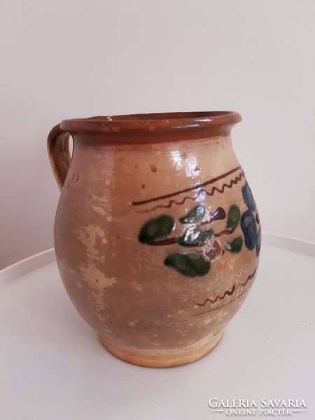 Old painted flower-patterned glazed mug