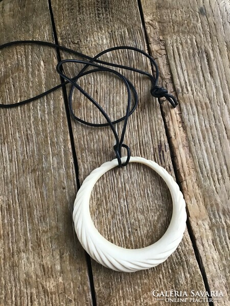Large carved bone pendant on cord necklace