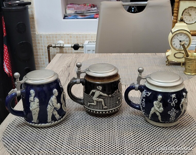 3 porcelain cups with tin lids. Bowling, soccer, tennis.