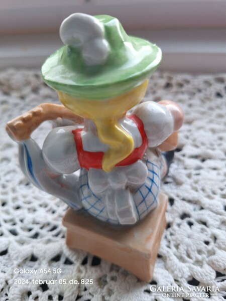 Porcelain figurine of a boy playing guitar