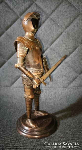 Nicely crafted metal knight armor! Sword and shield in hand! Coat of arms on the shield and also on the breastplate!